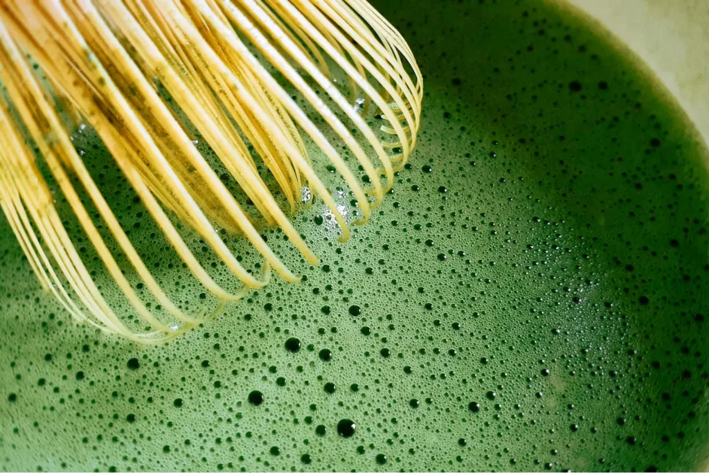 Matcha in bamboo bowl with whisk