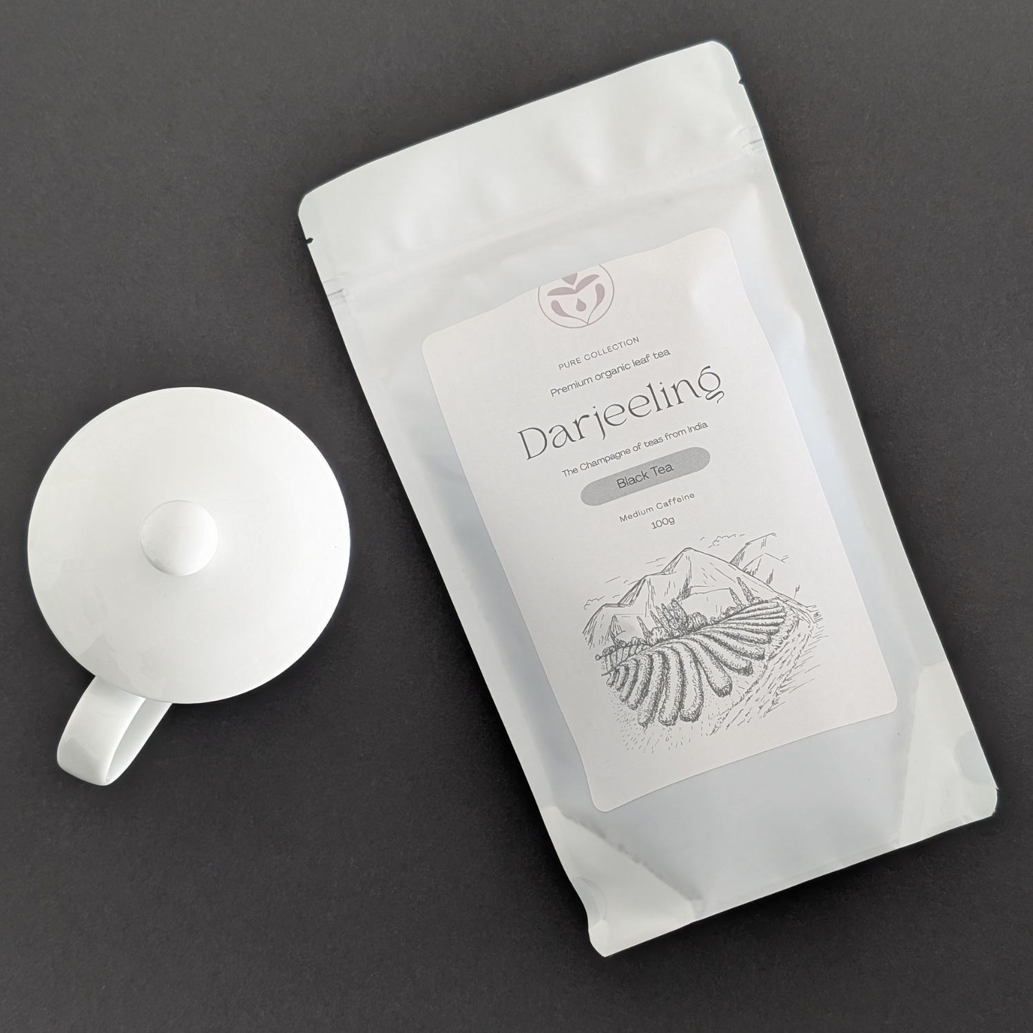 Organic Darjeeling First Flush tea packaging styled on table