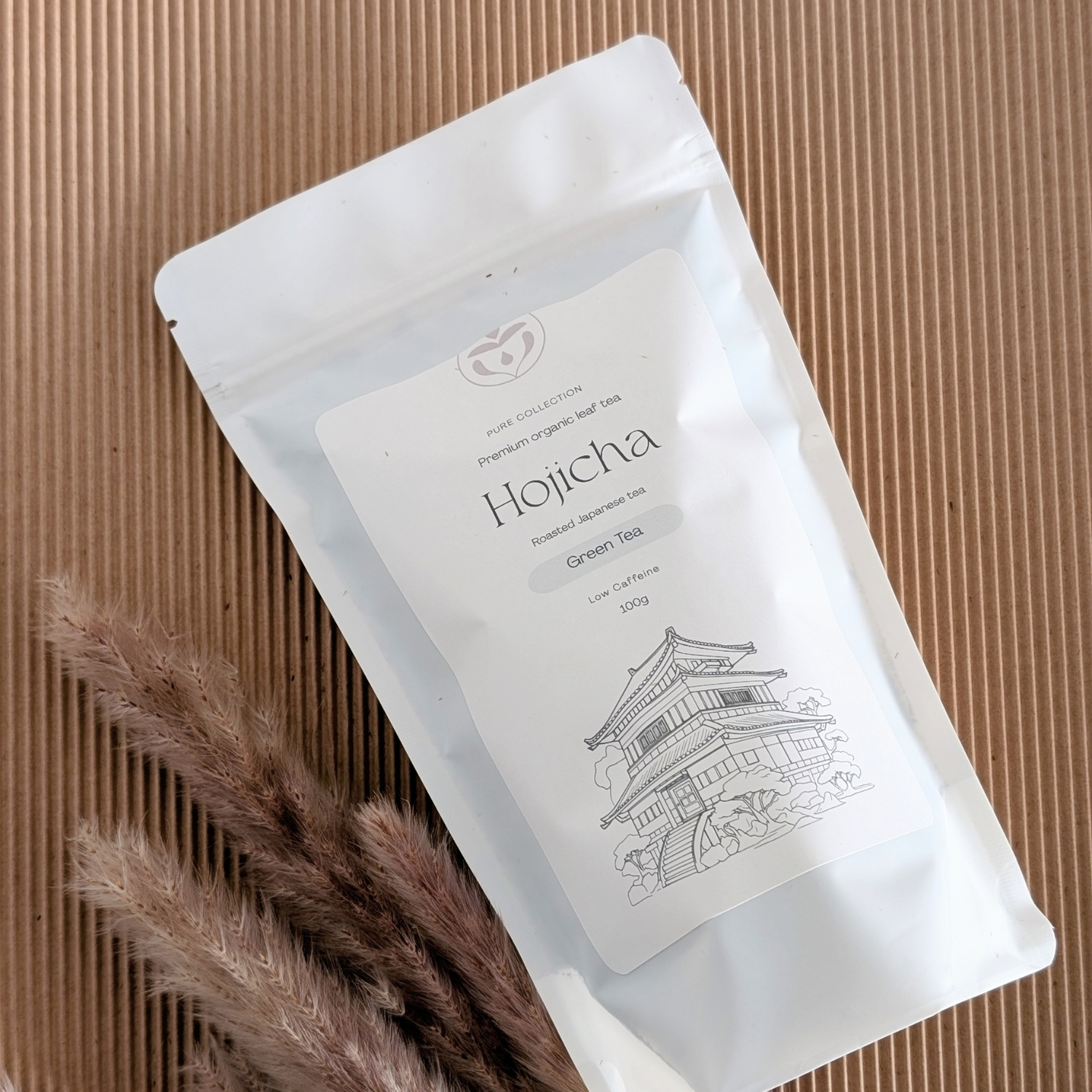 Organic Hojicha tea packaging styled on table